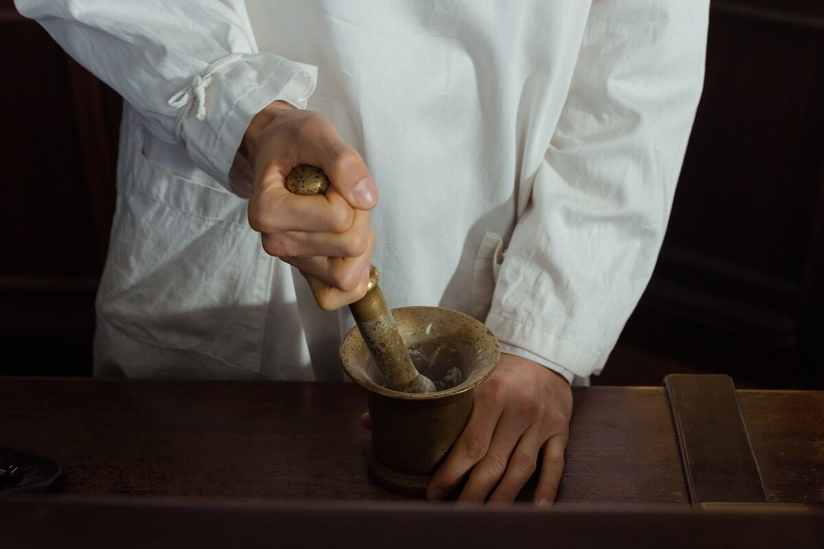 Medication being prepared with a mortar and pestle