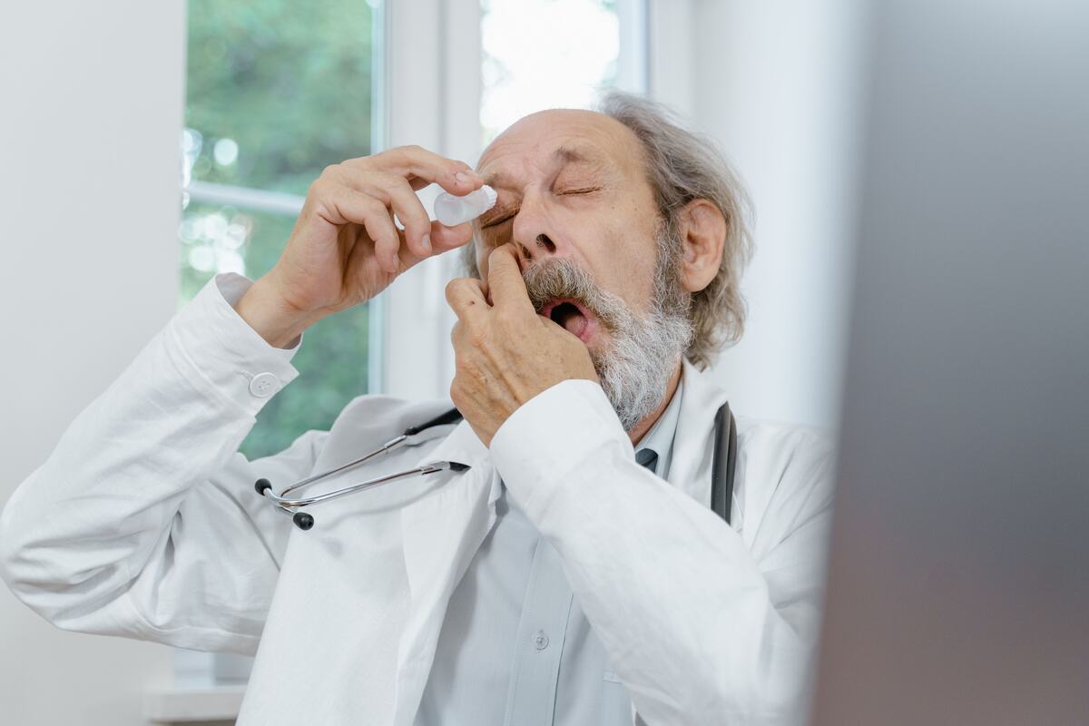 A patient putting in eye drops