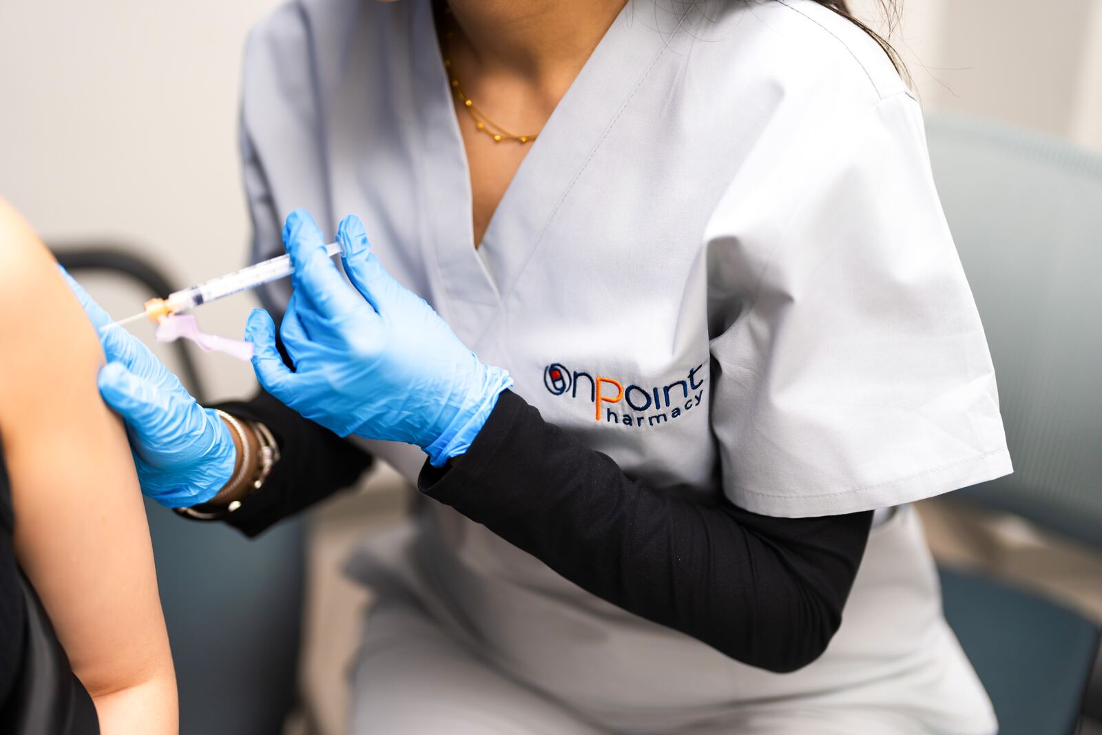 A pharmacist giving a vaccine at OnPoint Carle Place